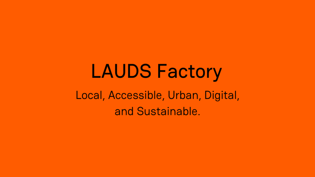 Ein orangefarbenes Banner mit dem schwarzen Text „LAUDS Factory“ und der Erklärung „Local, Accessible, Urban, Digital, and Sustainable“.